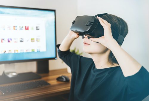 This picture show a woman using a VR set.
